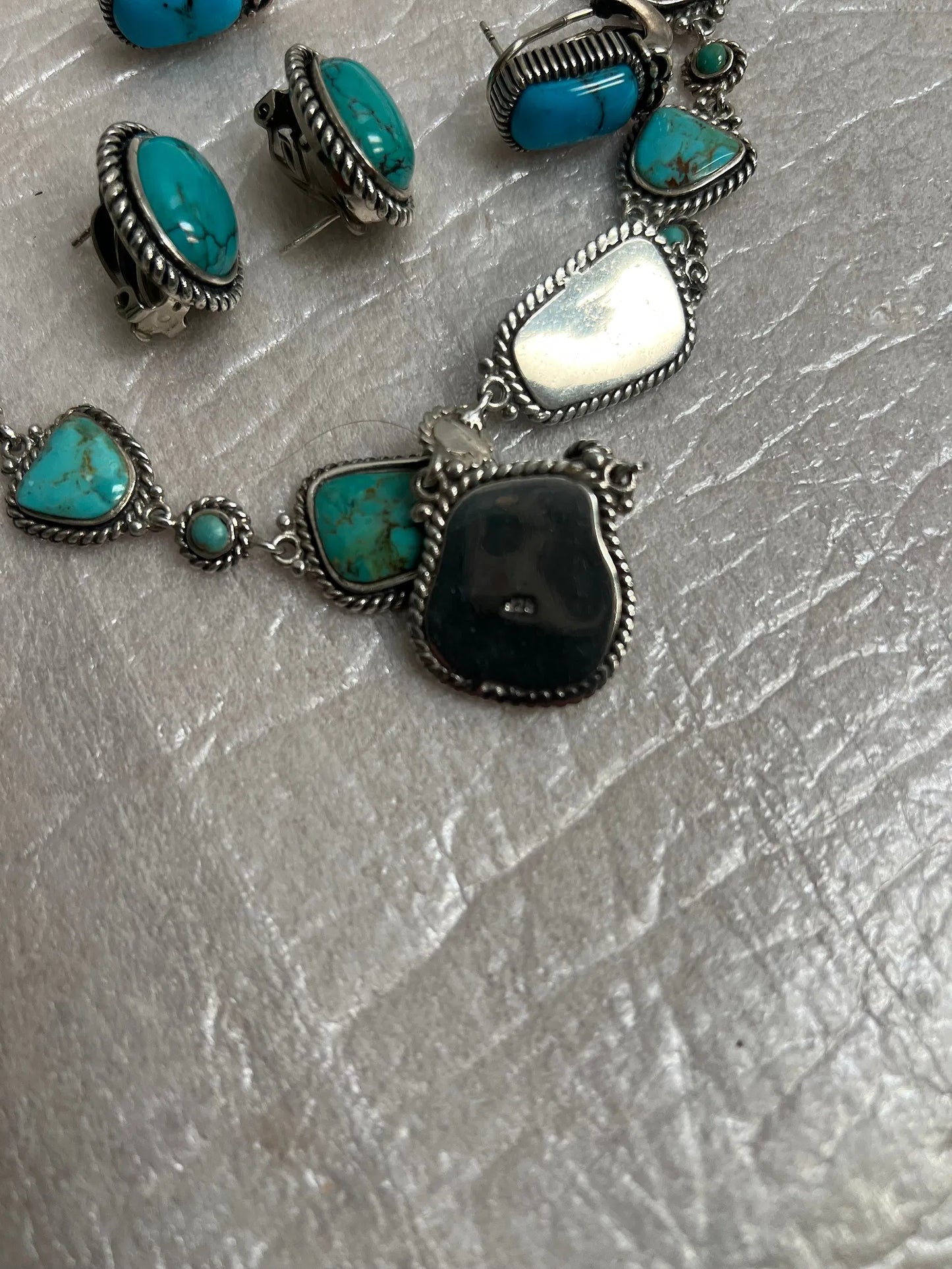 Native American-style sterling silver jewelry featuring prominent turquoise gemstones